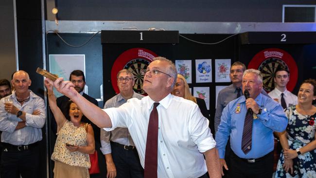 Scott Morrison flips the first round of two-up. Picture: Jason Edwards