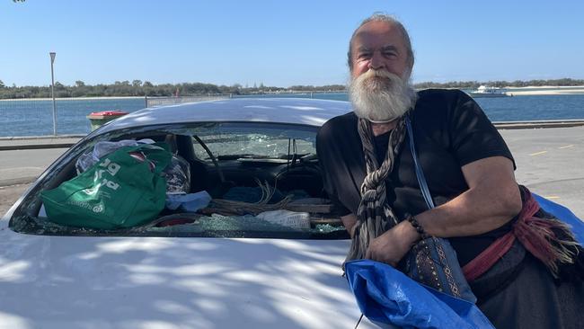 Edward Jacques in Labrador with the smashed car. Picture: Melanie Whiting