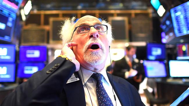 Trader Peter Tuchman watched as stocks tumbled on March 5, as fears grew of a global slowdown because of coronavirus. Tuchman recovered after contracting COVID-19 in March. Picture: AFP