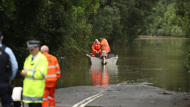 Police and SES on Cuthill Rd Cobbitty where parts of the road are completely underwater. Picture: John Grainger