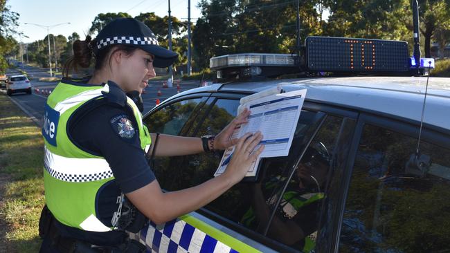 Constable Cass Grey issuing a fine during a Maroondah highway patrol breath testing and ANPR operation in Croydon. Picture: Kiel Egging.