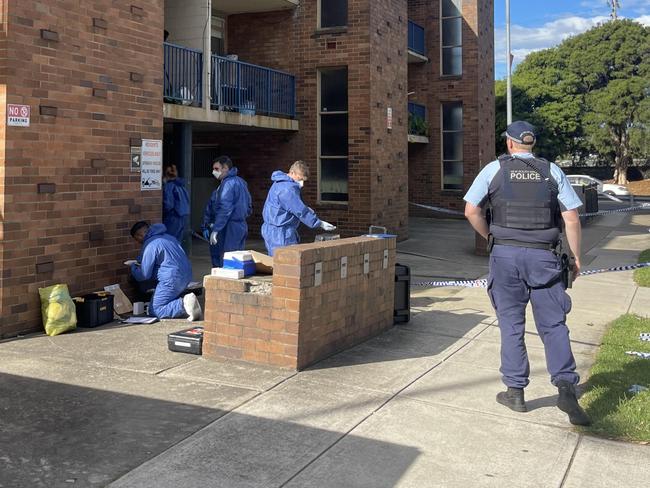 Police on the scene at a Merrylands apartment where the body of a woman was found.