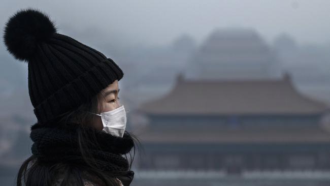 A Chinese girl wears a protective mask in Beijing as the number of cases of a deadly new coronavirus rise. Picture: Getty Images