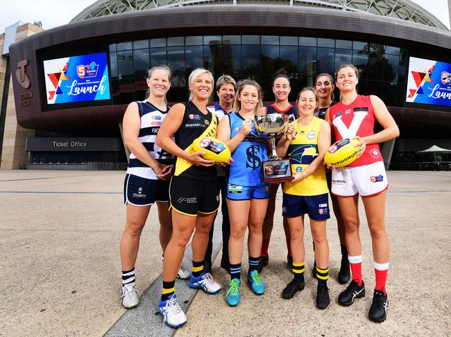 L-R Captains  South Adelaide - Lauren Buchanan ,Glenelg -  Cass Hartley , Centrals Assistant coach Natalie Seaman, Sturt Georgia Bevan, Norwood Leah Cutting,Eagles Adele Gibson, West Adelaide Lauren Rodato and North Adelaide Nadia Von Bertouch pose out the front of Adelaide Oval during the SANFLW launch  today Monday February 11,2019.(Image AAP/Mark Brake)