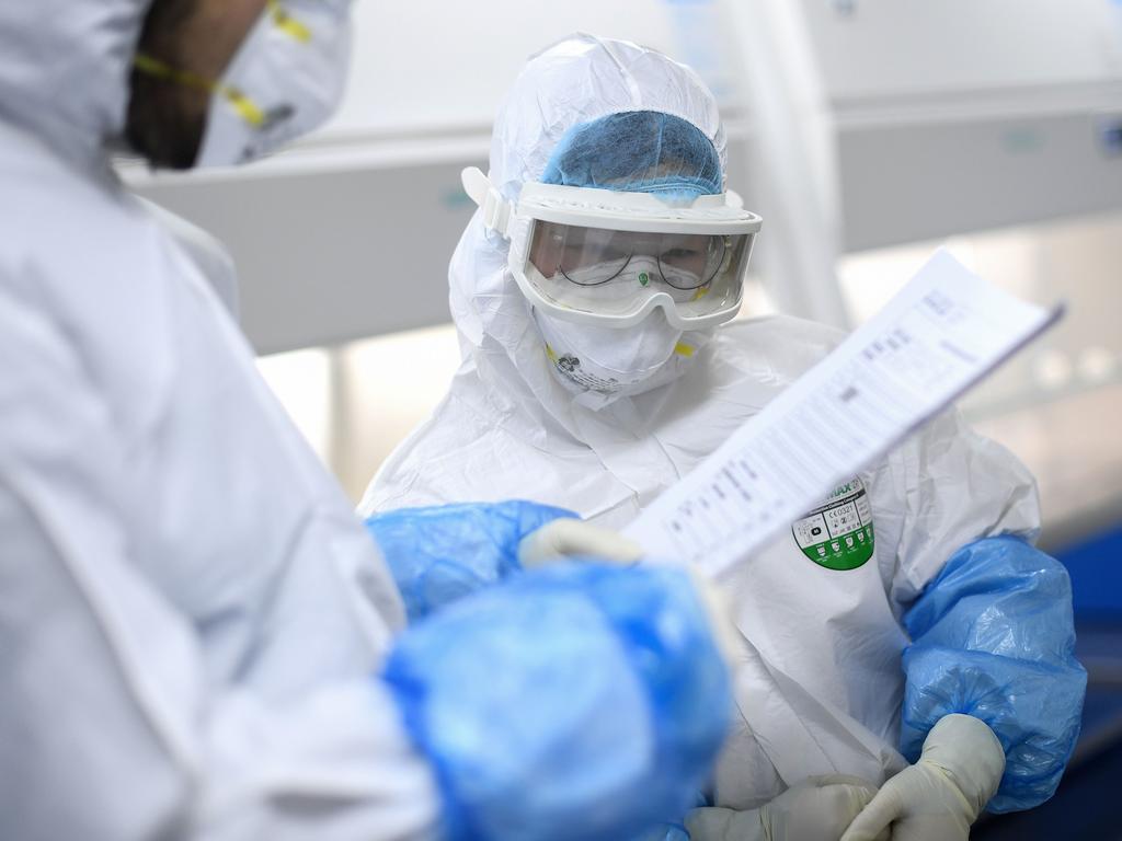 Lab technicians in Wuhan test for the virus. Picture: AFP