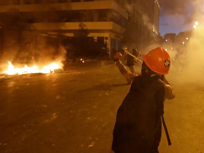 A Lebanese protester uses a slingshot against security forces. Picture: AFP