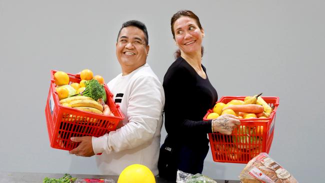 Kings Park food relief service Hands and Feet distributes hundreds of food hampers to churches across Sydney each week. Pictured, Kings Park Community Church pastor Ariel Cinco and Hands and Feet volunteer Marilyn Brown. Picture: Angelo Velardo