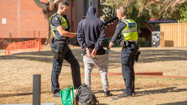 Police search and arrest a man in Richmond. Picture: Jason Edwards