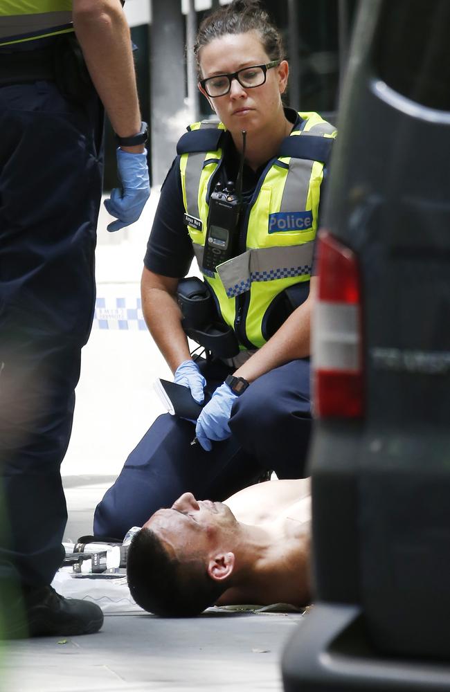 Police watch over Jimmy Gargasoulas after his arrest. Picture: David Caird