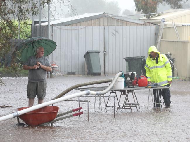 A flood warning has been issued for Berri and Renmark. Heavy rains overnight and rising river levels are expected to cause issues for lower lying areas. At Lirrup near Berri, Phillip Crouch surveys the water as an SES volunteer, continues pumping, after they had 106 mm of rain in about 8 hours. 24 October 2022. Picture Dean Martin