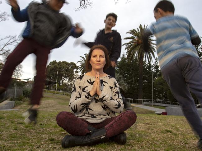 Photo of Elsternwick mum Vikki Friedman trying to meditate while her sons with her sons Hugo Friedman 13 years, Milo Friedman 11 years and  Luca Friedman 8 years run around on Friday 29 June 2018.   Photo Luis Enrique Ascui