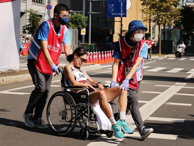 South Korean runner Kyungsun Choi is helped off in a wheelchair. Picture: Getty Images