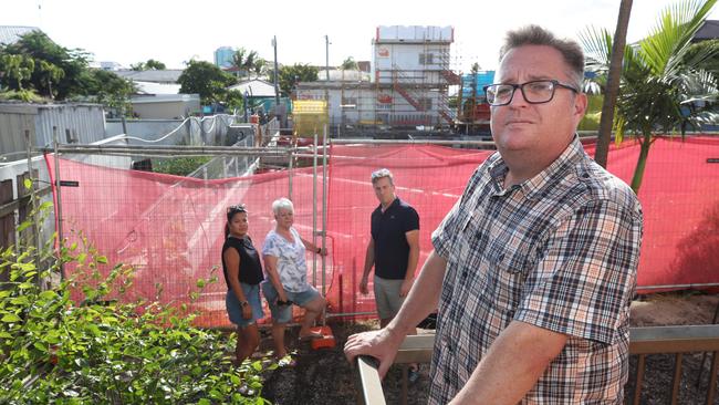 Chevron Island resident Nathan Skaines on his balcony with other concerned residents. Picture Glenn Hampson