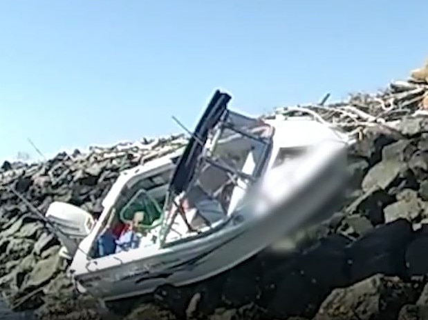 Boat on rocks at Port of Brisbane