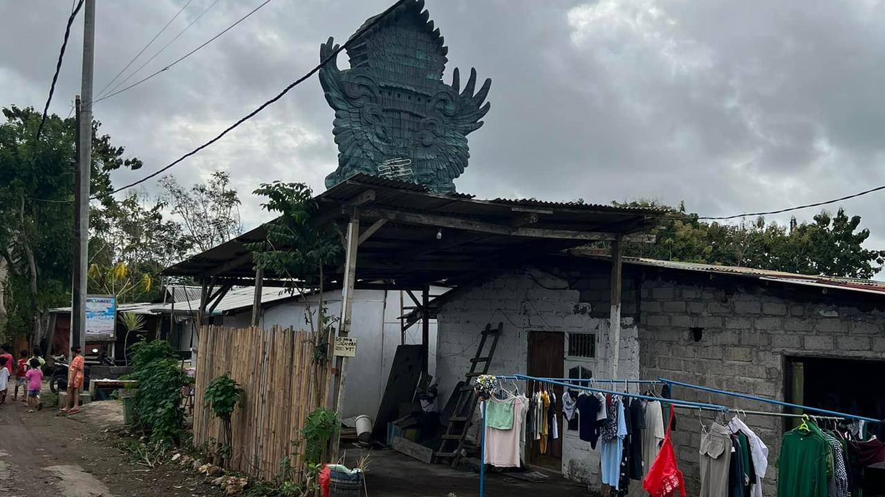 The statue can be seen behind the homes of locals. Picture: Dean Keddell