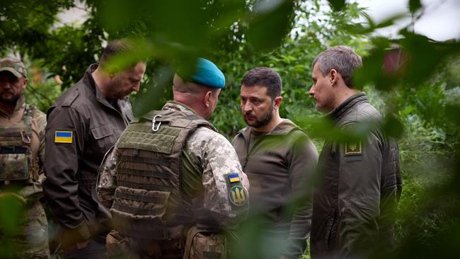 Ukrainian President Volodymyr Zelensky talks with officers during his visit to the forward positions of the Armed Forces of Ukraine in the Vugledar-Maryinka defense zone, Donetsk region.