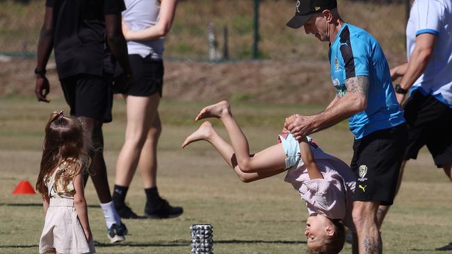 Trent Cotchins oldest daughter Harper with wrestling coach Greg Kleynjans and younger sister Mackenzie during a training session on the Gold Coast last year. Picture: Michael Klein