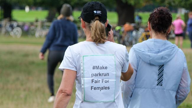 A female runner protesting at biological male runners being able to register as female and hold women's Park Run records is seen at the 20th anniversary of Park Run at Bushy Park, London. Photo: Jacquelin Magnay