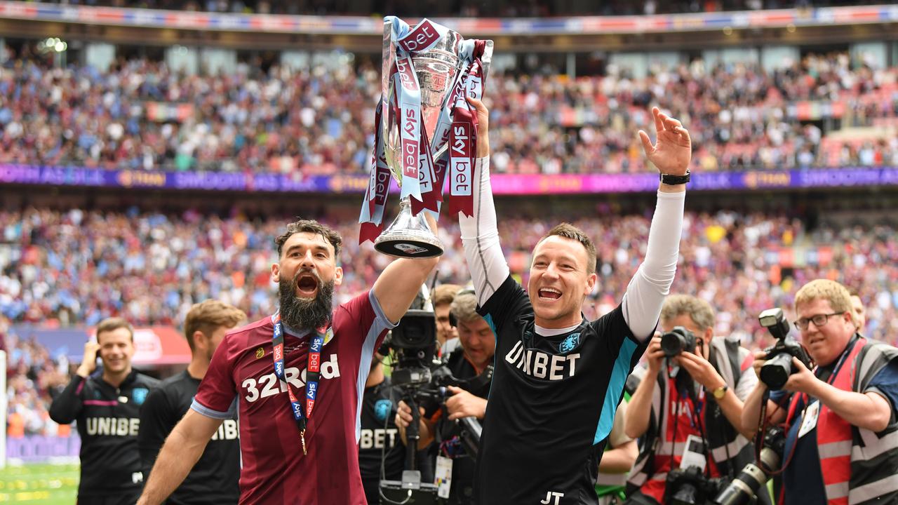 Mile Jedinak raising the Championship trophy with Aston Villa.