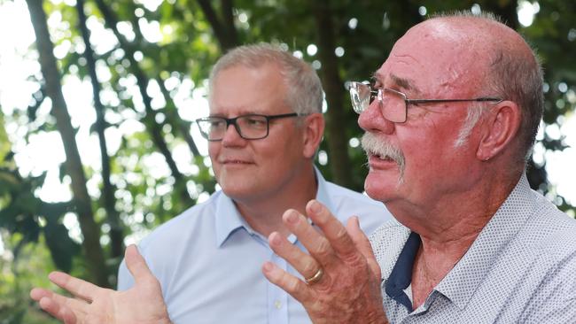 Prime Minister Scott Morrison watches Member for Leichhardt and special envoy for the Great Barrier Reef Warren Entsch speak at Green Island. Picture: Brendan Radke