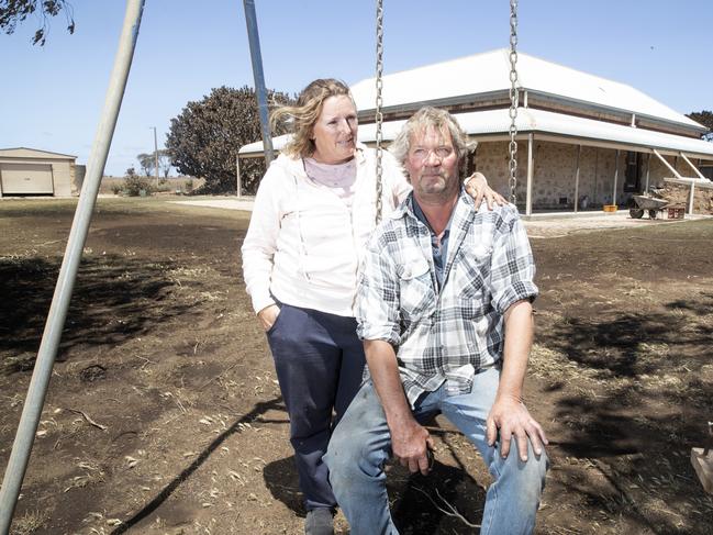 Brett and Donna Dalton at their house, which they managed to save from the bushfire. Picture: Simon Cross