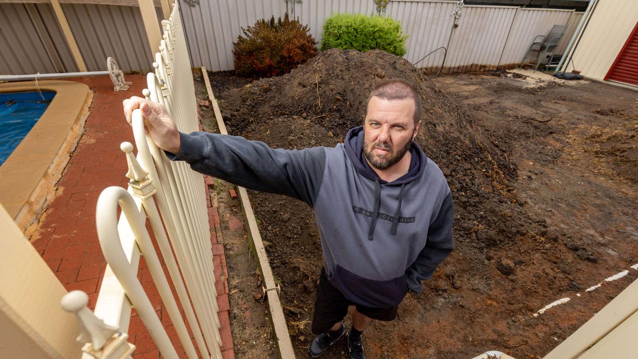 Keith after paying Adelaide Exposed Concrete to repair a retaining wall and re-landscape his lawn. Pictures: Ben Clark