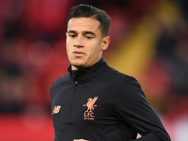 Liverpool's Brazilian midfielder Philippe Coutinho warms up before the UEFA Champions League Group E football match between Liverpool and Sevilla at Anfield in Liverpool, north-west England on September 13, 2017. / AFP PHOTO / Paul ELLIS