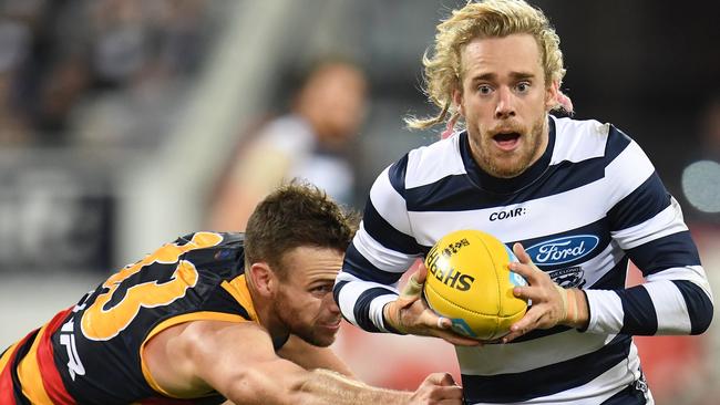 BREAKING AWAY: Geelong’s Cameron Guthrie breaks clear of Crow Brodie Smith during the Cats’ round 11 triumph at Kardinia Park. Picture: AAP