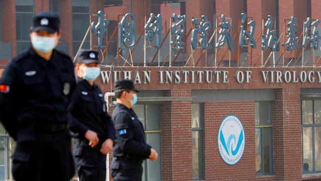 Security personnel keep watch outside the Wuhan Institute of Virology during the Covid pandemic. Picture: Reuters