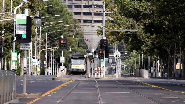 A tram makes its way through an empty street in Melbourne on February 13 during the five-day lockdown. Picture: Getty