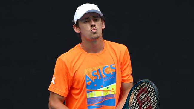 Alex de Minaur reacts during a training session ahead of the 2024 Australian Open. Photo by Graham Denholm/Getty Images.