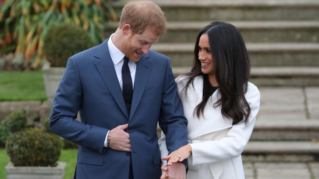 Prince Harry stands with his fiancee Meghan Markle as she shows off her engagement ring. Picture: Daniel Leal-Olivas/AFP