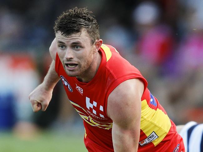 Pearce Hanley of Gold Coast Suns passes the ball during the AFL JLT Community Series match between the Gold Coast Suns and the Geelong Cats at Riverway Stadium in Townsville, Sunday, March 4, 2018. (AAP Image/Dave Acree) 