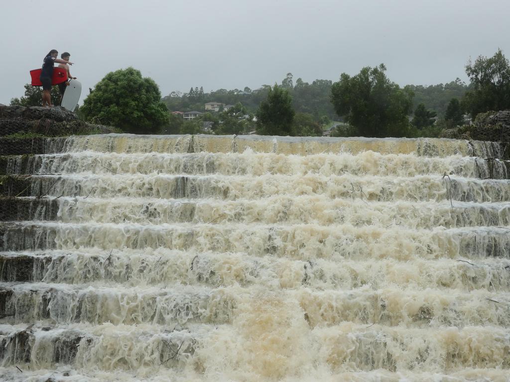 Wet weather continues to impact the Gold Coast. The floodwaters cascade from Flooded Gum Park at Pacific Pines. Picture Glenn Hampson