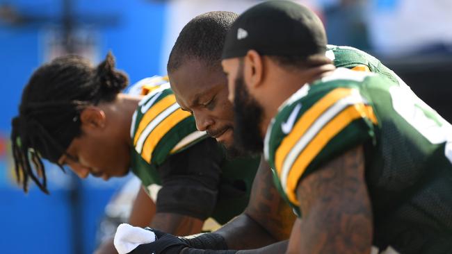 Green Bay Packers players sit in protest during the national anthem prior to the game against the Cincinnati Bengals. Picture: AFP