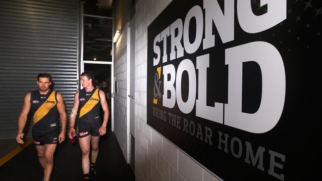 Brett Deledio and Jack Grimes lead Richmond out.