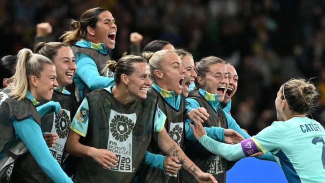 Australia's defender #07 Stephanie Catley (right) celebrates with teammates after scoring her team's fourth goal from the penalty spot during the 2023 Women’s World Cup Group B football match against Canada in Melbourne.