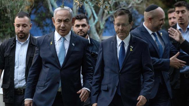 Israeli Prime Minister Benjamin Netanyahu walks with President Isaac Herzog.