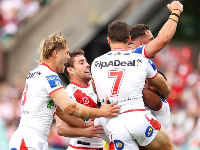 Francis Molo celebrates scoring the Dragons’ first try.