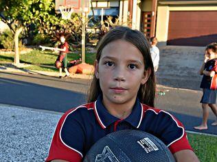 SLAM DUNK FINE: Kira Robinson, 10, uses the basketball hoop that has earned its owner a $650 fine from Sunshine Coast Council. Picture: Warren Lynam