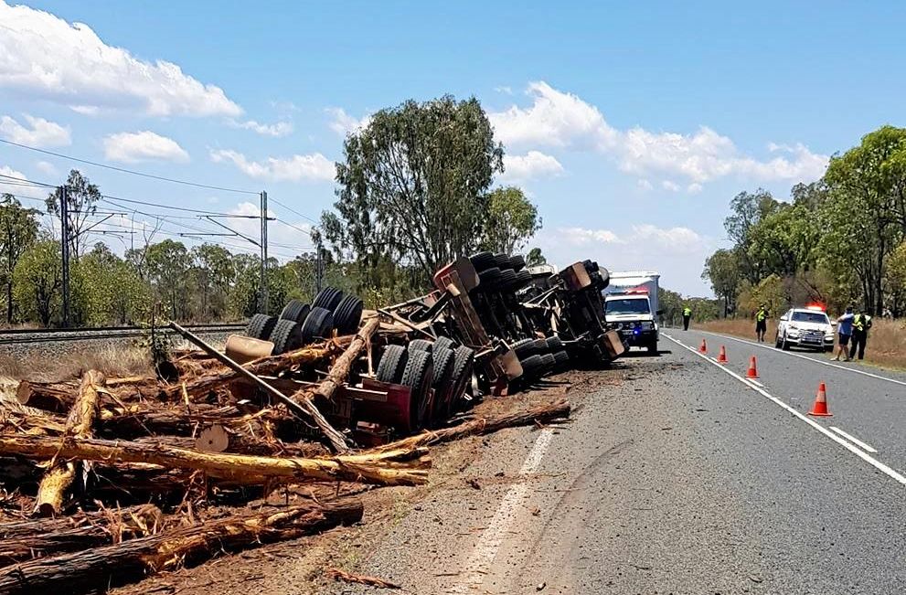 A truck carrying logs rolled on the Capricorn Highway on Wednesday morning. Picture: Michael Welburn