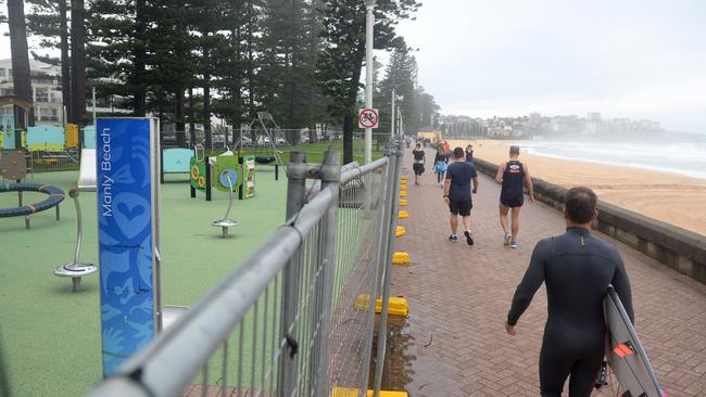 Residents in Manly take to the beach for early exercises during day three of lockdown. Picture: Jeremy Piper