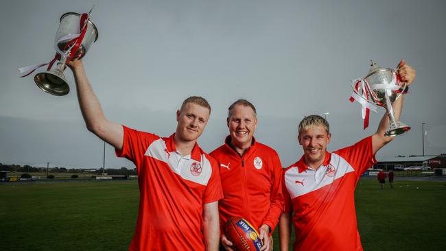 South Warrnambool’s Harry Lee, club president John Ross and Stuart Brown with senior and reserves Hampden league premiership cups. Picture: Nicole Cleary