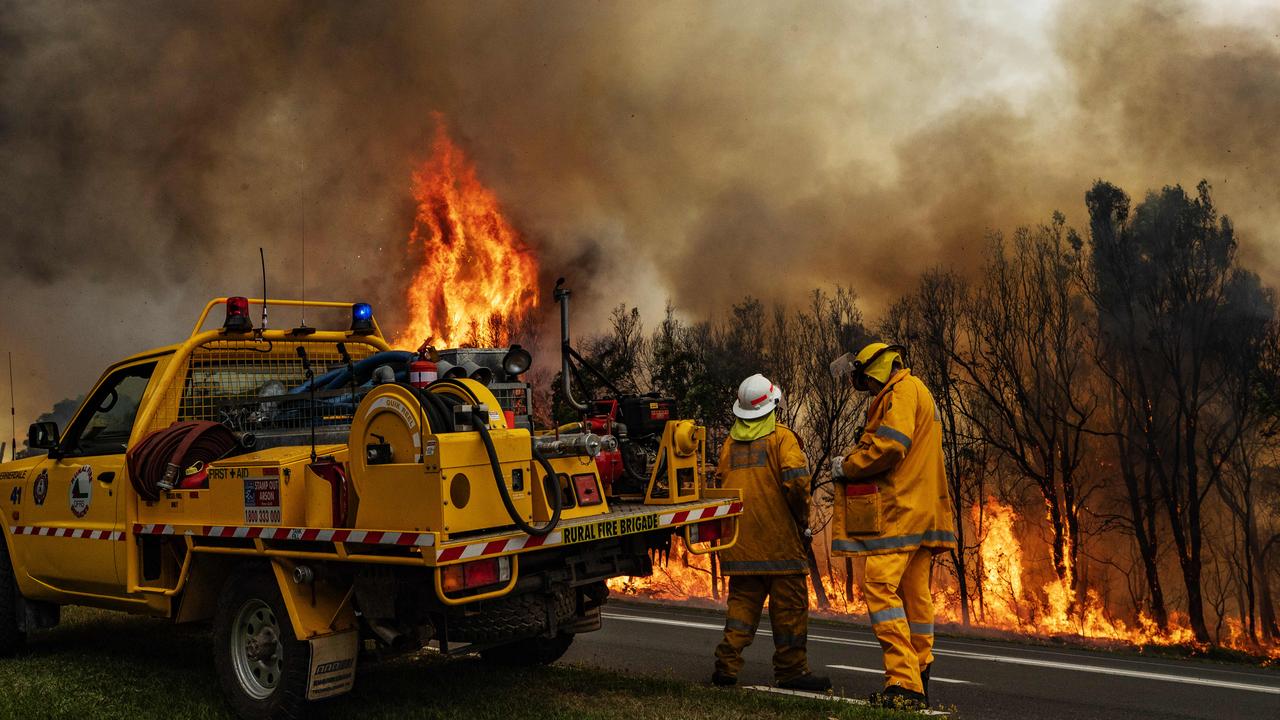 Firefighters on the scene at an out of control bushfire at Peregian Beach, where hundreds of residents were evacuated yet again. Photo Lachie Millard