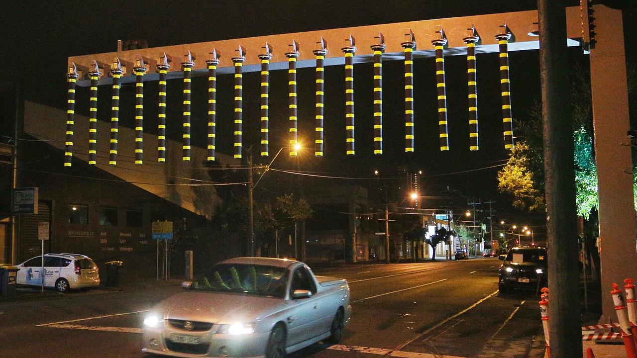 Bollards on Montague Street in the lead up to the low bridge designed to warn drivers to check their height. Since its installation, vehicles have continued to crash into the low bridge. Picture: Hamish Blair