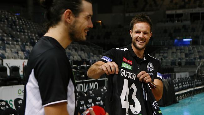 We’re pretty sure Melbourne United NBL star Chris Goulding is a mad North Melbourne fan and he doesn’t look too impressed with Nathan Brown trying to get him to wear a Collingwood jumper. Picture: Wayne Ludbey