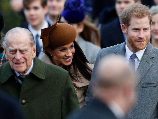 (FILES) In this file photo taken on December 25, 2017 (L-R) Britain's Prince Philip, Duke of Edinburgh, US actress and fiancee of Britain's Prince Harry Meghan Markle and Britain's Prince Harry (R) arrive to attend the Royal Family's traditional Christmas Day church service at St Mary Magdalene Church in Sandringham, Norfolk, eastern England. - Prince Harry and wife Meghan Markle's foundation Archewell paid tribute to Britain's Prince Philip following his death on April 9, 2021 as speculation builds about their plans to attend the funeral. (Photo by Adrian DENNIS / AFP)