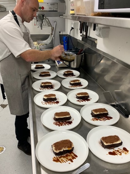 Sous Chef Darryl puts the finishing touches on a Parisian tart during his visit.