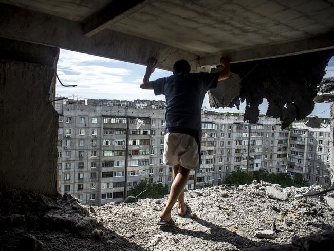 Long-Term Projects - First Prize © Valery Melnikov, Rossiya Segodnya Title: Black Days Of Ukraine A man inspects a damaged building in the Mirny district of Luhansk. Story: Ordinary people became victims of the conflict between self-proclaimed republics and the official Ukrainian authorities from 2014 onwards in the region of Donbass. Disaster came into their lives unexpectedly. These people were involved in the military confrontation against their will. They experienced the most terrible things: the death of their friends and relatives, destroyed homes and the ruined lives of thousands of people.