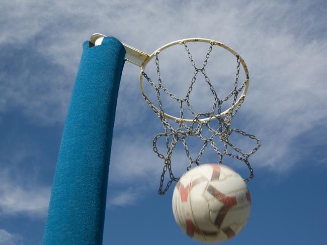 Netball ring with the ball being thrown through the hoop